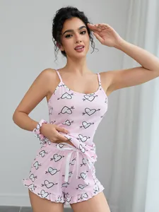 Close-up detail of a pink two-piece pajama set with a cute heart and arrow print
