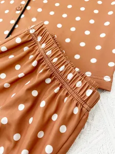 Close-up detail of terracotta white polka dot pajama pants with elastic waistband