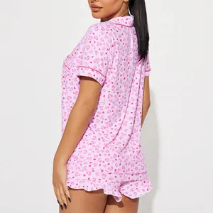 Comfortable women's pink heart print pajama set with short sleeves and ruffled shorts