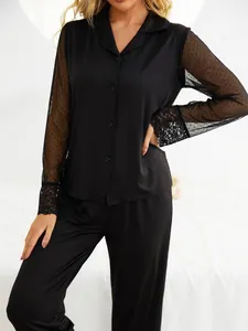 Detail of black modal pajama set with elegant mesh and lace sleeves.