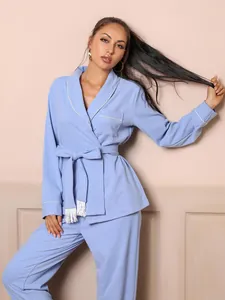 Women's light blue pajama set featuring white piping and a stylish belted tie waist.