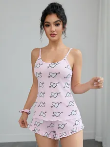 Pink heart print camisole and shorts two-piece pajama set beautifully shown on a model.