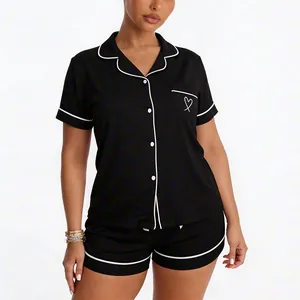 Elegant black women's summer pajama set with short sleeves, shorts, and heart pocket detail