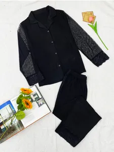 Detailed view of black modal pajama set with mesh polka dot sleeves and lace trim