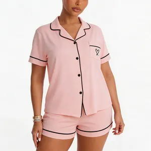 Pink short sleeve pajama set with black contrast piping and heart detail