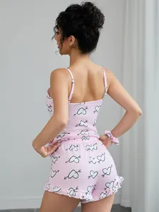 Detailed back view of pink two-piece pajama set featuring heart print and ruffled shorts