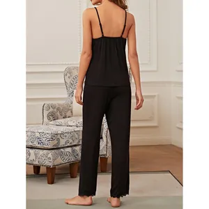 Women's black pajama set featuring sexy mesh camisole and long pants loungewear style