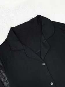 Close-up detail of black modal pajama top with soft lapel collar and mesh sleeve design