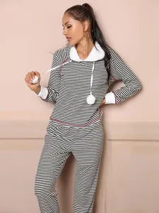 Detailed view of women's black and white striped hooded loungewear set with pom-poms