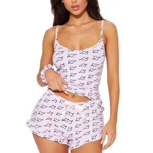 Sexy pink two-piece pajama set for women with heart print camisole and ruffled shorts.