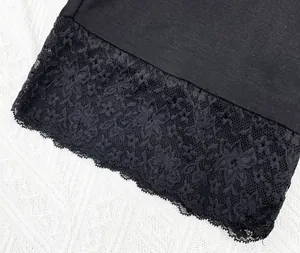 Macro view of exquisite floral lace embroidery on high-quality black modal fabric hem