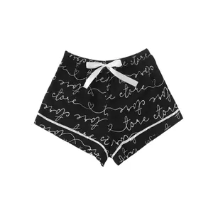 Casual black women's pajama shorts with white script print and silk bow ribbon detail