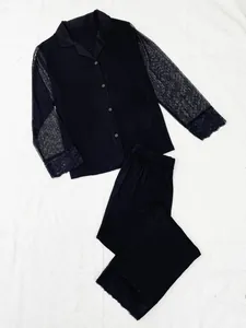 Close-up detail of a black modal pajama set featuring lace trim and mesh sleeves