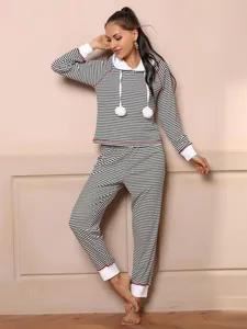 Cozy women's black and white striped hooded pajama set featuring soft pom-poms and cuffs