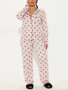 Women's pink butterfly print pajama set with long sleeves and lapels for loungewear.