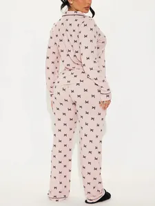 Back view of light pink butterfly print pajama set featuring long sleeves and pants