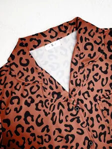 Detailed view of leopard print pajama collar featuring size S tag and silk texture