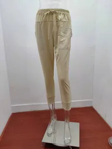 Detail view of beige cotton linen casual jogger pants with drawstring waist.
