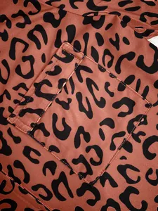 Detailed close-up showing leopard print fabric and pocket stitching of women's pajama set