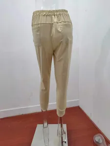Detailed back view of minimalist beige women's cotton linen tapered casual trousers