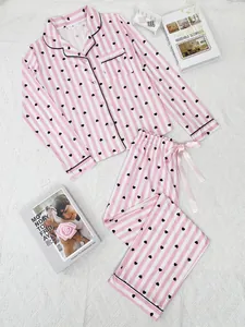 Overview layout of heart print striped pajamas with decorative books on textured rug