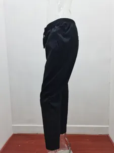 Side view detail of women's black cotton linen drawstring casual pants with slim fit