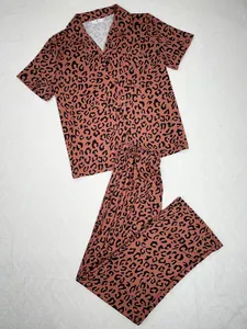 Two-piece women's leopard print pajama set featuring short-sleeve top and long pants.