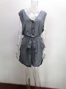 Detail view of a gray sleeveless V-neck romper with button front and bow tie waist