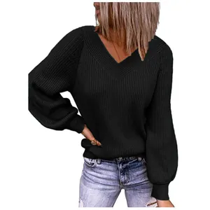 Detail view of a loose-fitting black oversized V-neck knit sweater with ribbing texture
