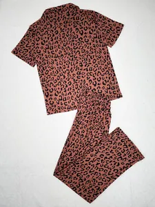 Two-piece leopard print pajama set featuring short sleeve lapel top and long pants
