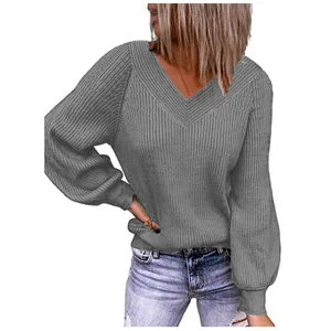 Close-up of grey V-neck oversized knitted sweater with ribbed cuffs for women