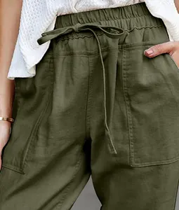 Detail shot of olive green cotton linen casual pants with drawstring waist and pockets