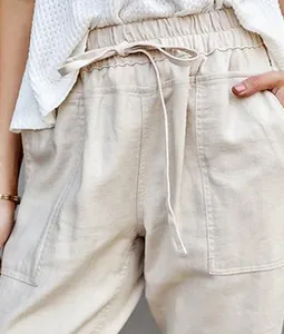 Close-up detail of beige cotton linen drawstring casual pants for women with elastic waist