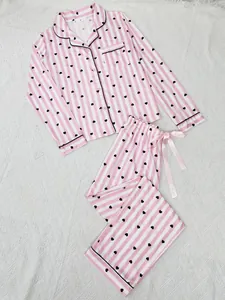 Women's pink and white striped two-piece pajama set featuring black heart prints