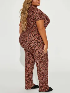 Side view of women's two-piece leopard print pajama set with short sleeves and long pants