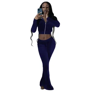 Two-piece navy blue velvet tracksuit featuring a cropped zip-up hoodie and flared pants.
