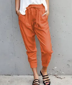 Detail of summer cotton linen tapered pants in bright orange with lace-up waist