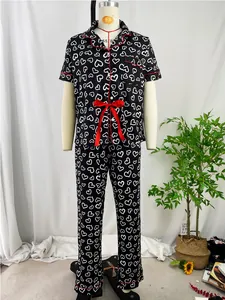 Full view display of heart print pajamas set on a mannequin with white curtain background