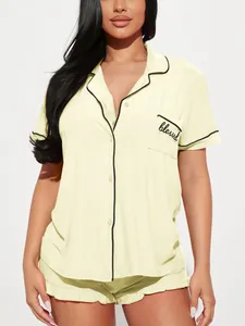 Détail du pyjama pour femme jaune pâle avec liseré noir et poche texte blessed