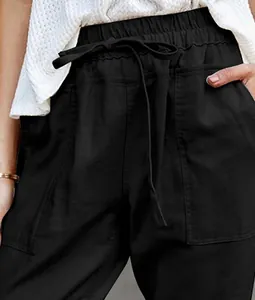 Close-up of black cotton linen casual pants with elastic drawstring waist and side pockets