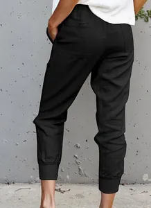 Detailed back view of women's black cotton linen joggers showing slim fit and cuffed ankles.