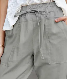 Close-up detail of gray cotton linen casual pants featuring drawstring waist and pockets
