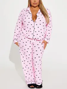Detailed shot of pink and white striped pajama set with black heart print and lapel