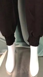 Detailed view showing smocked elastic cuffs of these black casual harem yoga pants
