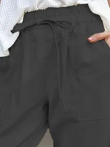 Detail of cotton linen casual pants with elastic drawstring waist and pockets