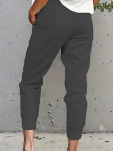 Back view detail of slim-fit women's dark grey cotton linen cropped jogger pants