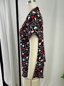 Side view detail of women's heart print pajama set on a mannequin with red piping trim