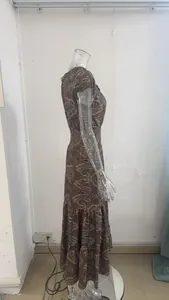 Side profile view of a bohemian style paisley print maxi dress displayed on a clear mannequin.