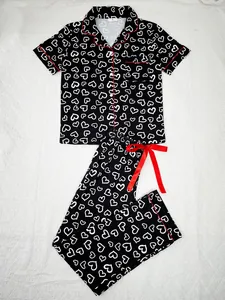 Two-piece women's heart print pajama set featuring short sleeve top and long pants