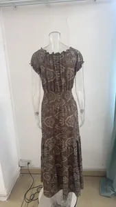 Detail of the bohemian paisley print on a brown maxi dress with an elastic waist.